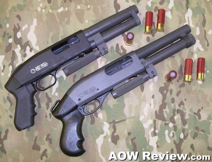 Two compact pump shotguns with red shotgun shells on camo
