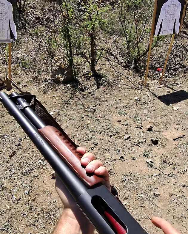 Racking a Remington pump-action shotgun at the range